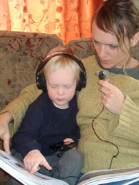 mother reading to son using audio amplifier