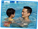 Picture of child swimming with dad.