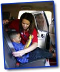 Picture of mom putting baby into carseat