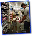 Picture of dad and daughter picking out shoes